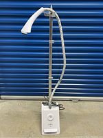 Full view of white Pure Enrichment garment steamer with adjustable metal pole and hose.