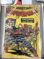 Front cover view of The Amazing Spider-Man comic book issue 25 showing the main cover art with Spider-Man caught in tentacles and J. Jonah Jameson in background on yellow cover with Marvel and Comics Code logos.
