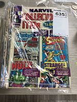 Top view of comics in protective plastic showing Marvel Collectors' Item Classics cover with Hulk, Fantastic Four, Strange Tales and Suspense comics.