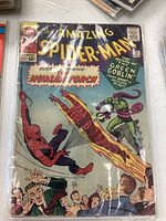 Full front cover view in protective sleeve showing artwork and overall condition