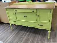 Front view of painted sideboard showing top, drawers, doors and legs