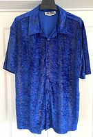 Full front view of 1990s men's Pop Icon short sleeve shirt in blue abstract pattern on hanger.