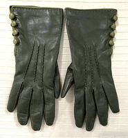 Top view of pair of dark green leather gloves showing three buttons on side of each glove.
