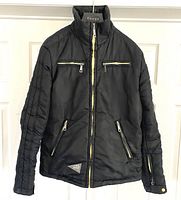 Full front view of black nylon bomber jacket with zippers and Diesel logo patch on lower front.