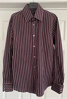 Full view of men's long sleeve Hugo Boss dress shirt with vertical stripes.