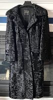 Front view of the black fur coat, showing full length and textured pattern.