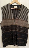 Front side view of vintage John Slim men's sleeveless knit vest showing button closure and textured stripe patterns