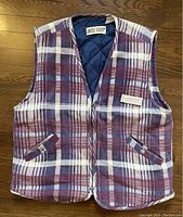 Front view of vintage Limited Stock men’s vest showing plaid pattern and button pockets