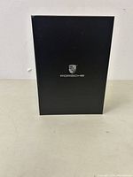 Closed black box with Porsche logo centered on the front.