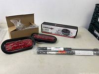 Photo showing the 3/16 inch winch rope box by Fieryred, bike reflectors/lights in protective plastic, and two gas lift struts, all new and unpackaged.