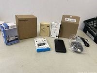 Photo showing the six items arranged on a table including boxes and accessories