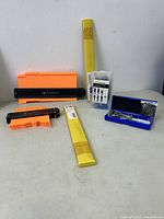 Full view of lot with profiling gauges, saw blades set, accessory case, and rulers.