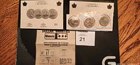 Three 1997 Canadian dollar coins of different types mounted on card backing with descriptive labels.