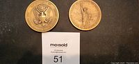 Photo of two US commemorative medallions, one showing the US government seal and the Statue of Liberty, placed on black background with seller tag.