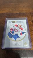 Hockey card featuring Arber Xhekaj in Canadiens uniform from SP Top Rookies series, protected with plastic sleeve.