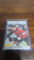 Holographic Brady Tkachuk rookie hockey card with color photo in Ottawa Senators uniform, encased in a plastic protective sleeve and hard case.