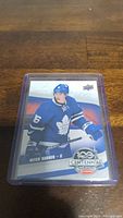 Photo of Mitch Marner rookie card in protective case, showing front side with player in Toronto Maple Leafs jersey.