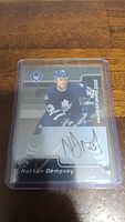 Photo of Nathan Dempsey 2002 Signature Series autograph hockey card in protective case.