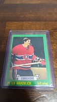Front view of Peter Mahovlich hockey card in red Montreal Canadiens uniform, encased in protective plastic sleeve.