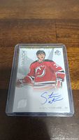 Photo showing front of Steven Santini signed rookie hockey card inside clear protective holder.