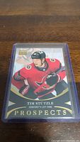 Front view of Tim Stutzle rookie hockey card from Upper Deck Prospects series in a plastic protective sleeve, with Ottawa Senators colors and logo visible.
