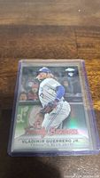 Front view of Vladimir Guerrero Jr. rookie baseball card in protective sleeve on table.