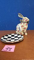 Bunny figurine and saucer set showing floral and checkerboard design