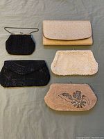 Top view of all 5 vintage evening purses showcasing different colors, beadwork styles, and closures