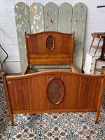 Full front view of assembled bedstead against decorative backdrop