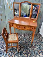Full view of Edwardian vanity and chair, showing wood finish, mirror, and chair cane seat.