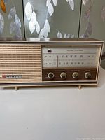 Front view showing radio front grille, control knobs, tuning scale and Panasonic logo.