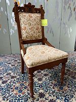 Full view of Victorian Eastlake wood chair showing wood detail and upholstered seat and back.