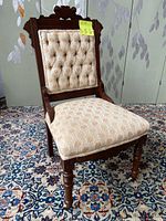 Side view showing chair upholstery and wood legs with caster wheels