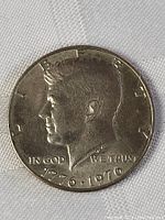 Obverse side showing the profile of JFK and dates 1776-1976