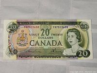 Front side of the 1969 Canadian $20 banknote showing Queen Elizabeth II and the Canadian coat of arms with serial number YB7512658.