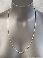 Full view of the sterling silver necklace displayed on a mannequin bust showing length and shape.
