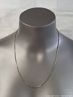 Front view of the necklace displayed on a mannequin bust showing length and fit.