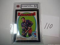 Front of the 1971 O-Pee-Chee Bobby Rousseau hockey card showing player photo and grading label