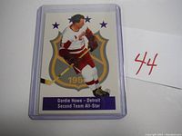 Front image of Gordie Howe hockey card showing player in Detroit Red Wings uniform, 2nd Team All-Star designation, encased in plastic sleeve.