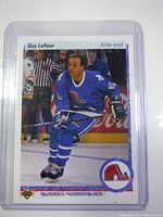 Front view of the 1990 Upper Deck Guy Lafleur hockey card showing the player in Quebec Nordiques uniform with French text and logos.