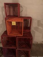 Image showing 8 plastic crates stacked with one orange WaWa crate on top