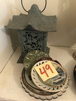 Wrought iron lantern with several decorative plates stacked together