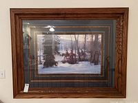 Framed and matted giclee print of Native American scene in winter landscape with horses and riders, viewed straight on showing full frame and matting.
