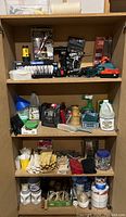Three-shelf overview with tools, cleaning and painting accessories, hardware and gloves