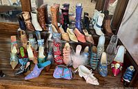 Overall lot of miniature shoes showing various styles including boots, heels, mules and slippers in diverse colors and designs