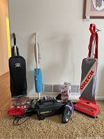 Overview of six vacuums showing upright, stick, handheld and canister styles