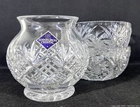 Photo of the footed rose bowl with Edinburgh Crystal label visible, showcasing the intricate Balmoral cut crystal pattern and curved shape.