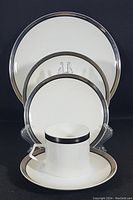 Full view of the five-piece set showing dinner plate, salad plate, bread plate, saucer, and flat cup from front