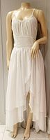 Full view of the white Reds Hall women's maxi dress on a mannequin showing the tiered skirt and fitted bodice with spaghetti straps.