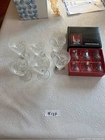Photo showing all 6 etched crystal stem glasses and 6 small goblets in Christal d'Arques box, arranged on table.
